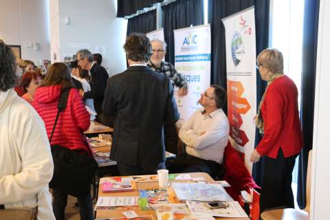 a group of people standing around a table